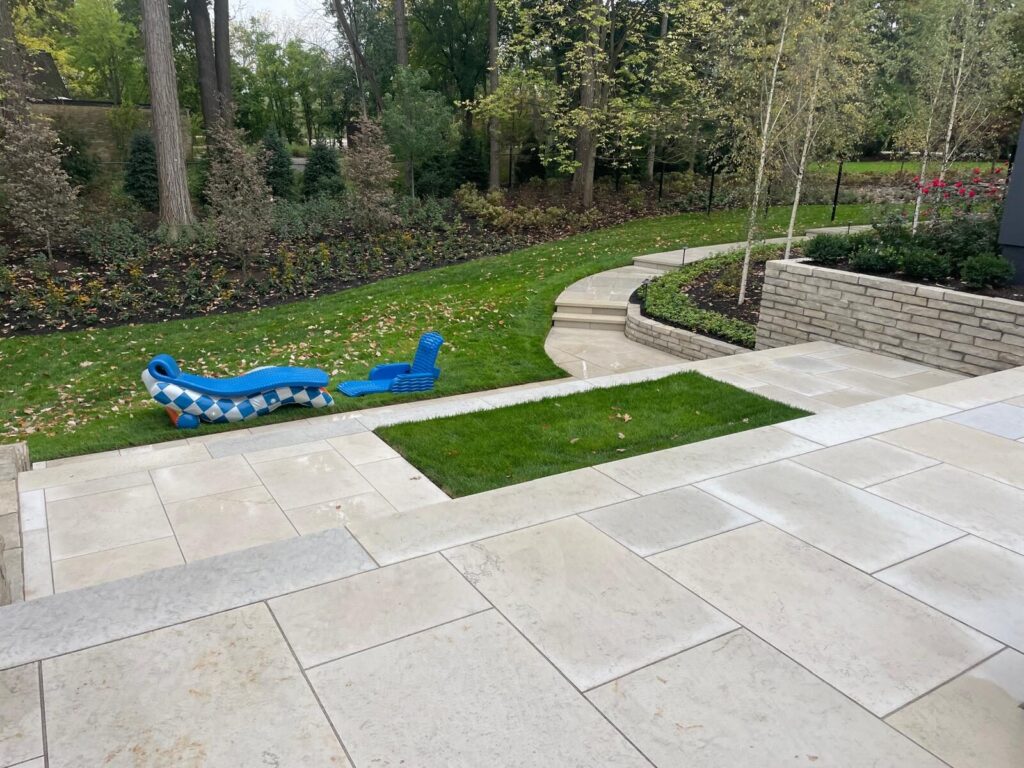 Backyard remodel with paver patio and lawn insets